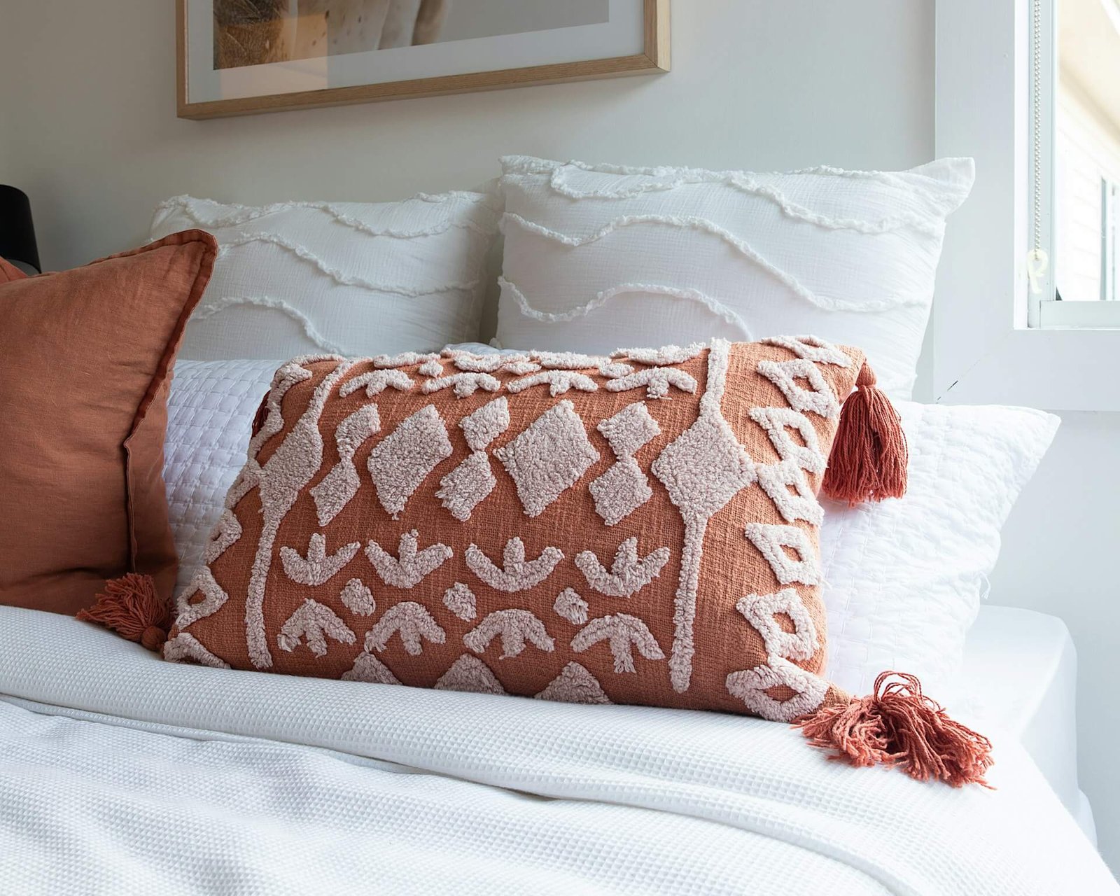 light orange pillows on a white bed