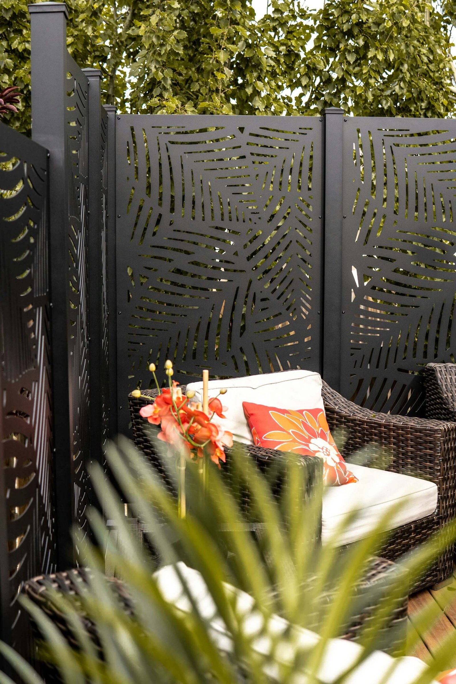 modern black screen divider with outdoor wicker chairs